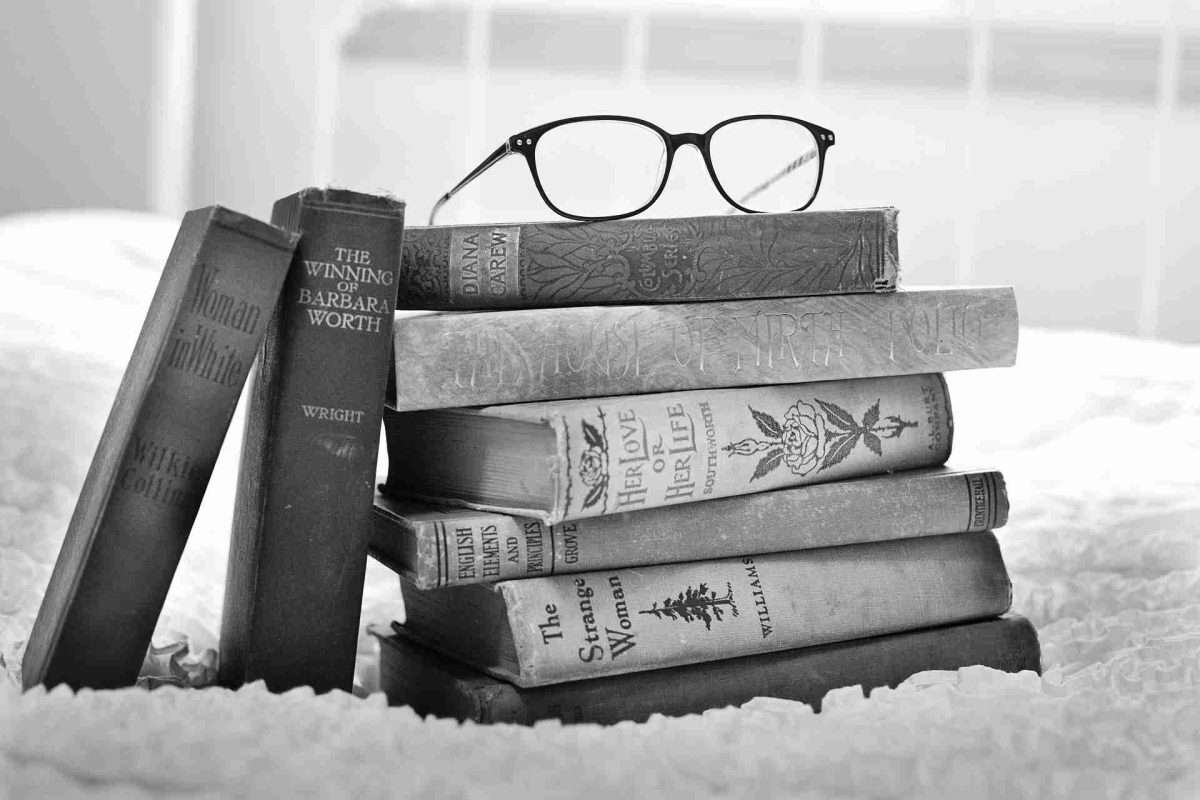 stack of books with glass on top, black and white photo