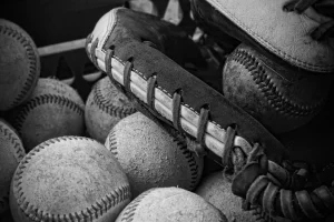 black and white photo, baseball glove and balls, dirty