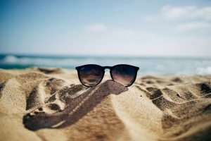 sunglasses on beach, relaxing, beachcombing.