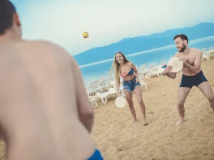 3 people playing on the beach