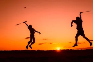 sunset playing badminton