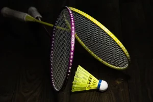 2 racquets, yellow shuttlecock