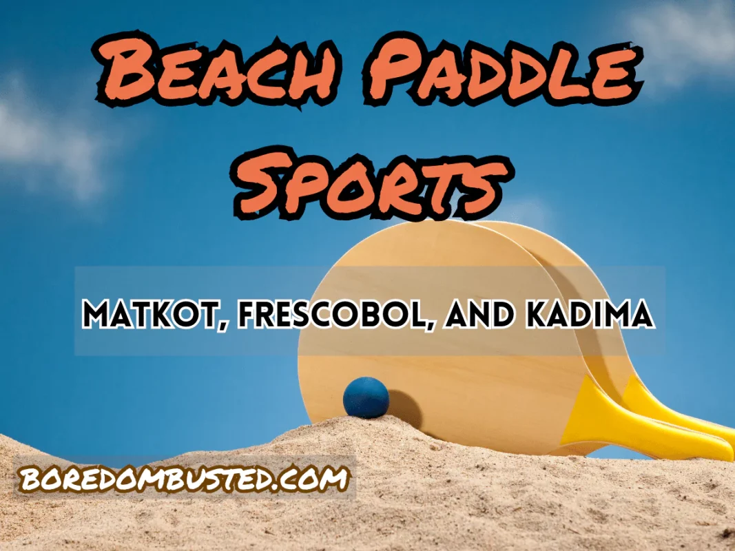 Beach paddle ball game featuring featured image "beach paddle sports" "motkot, frescobol, and kadima". 2 wooden paddles upright in the sand, blue rubber ball