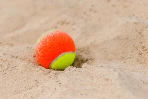 beach-tennis-ball-in-sand