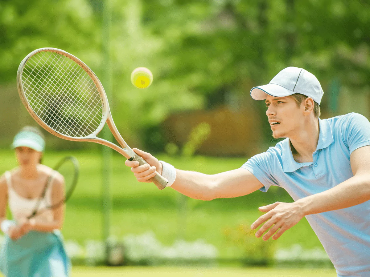 man-with-racket-hitting- tennis ball