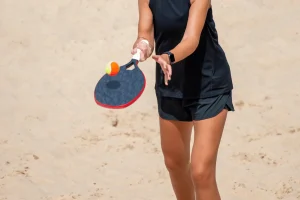 woman-playing-beach-tennis-on-beach