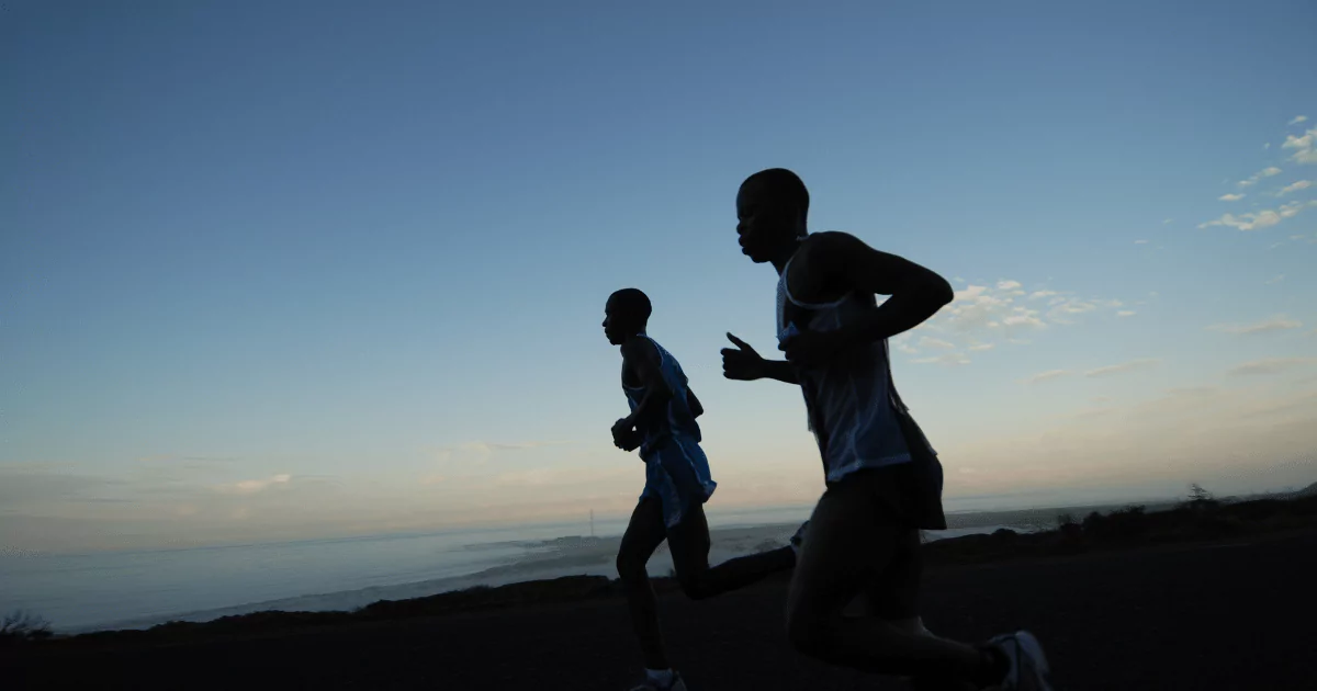 2 marathon runners along beach at dusk 6489c149cf08d