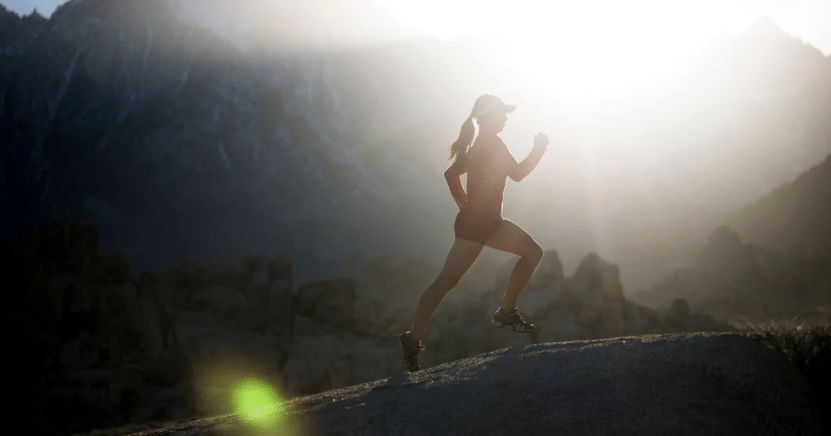 woman running through hills in red athletic gear 6489c1567b3fd