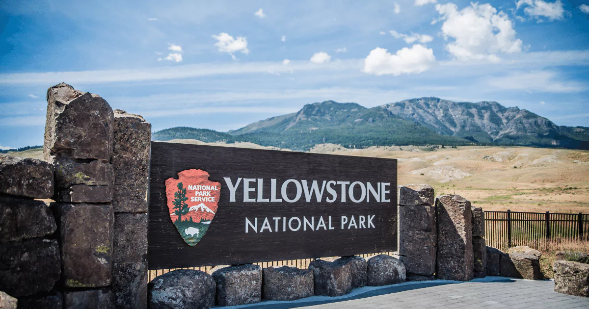 yellowstone national park sign desert and hill in background 64875638da1df