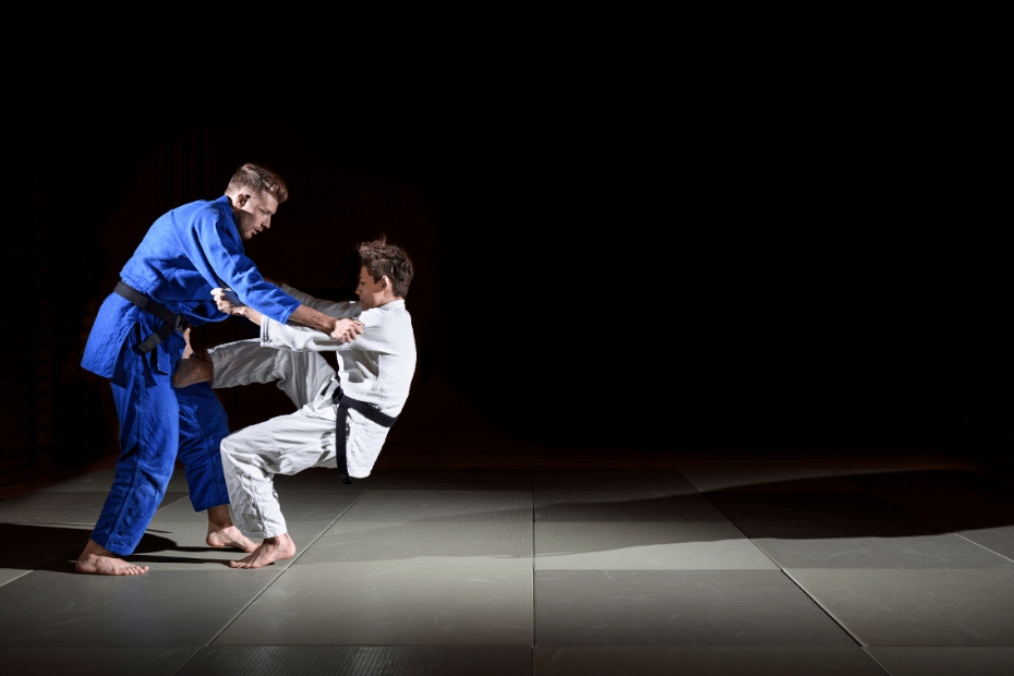 Two men practicing judo on a dark background