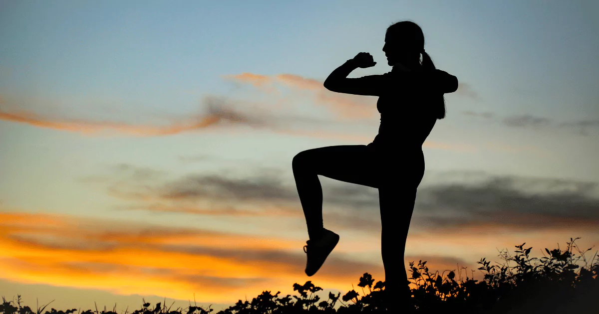 silhouette of a woman, dusk, leg raised in pose