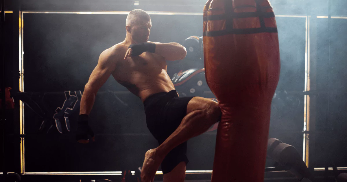 a man in a boxing ring, red punching/kicking bag
