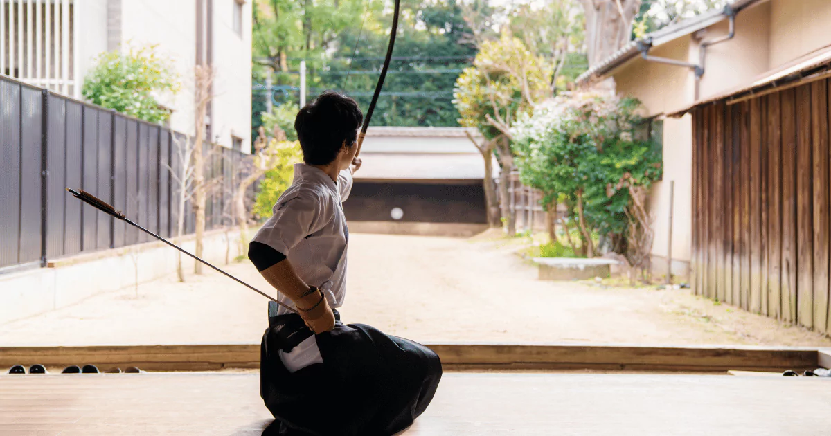 A Japanese man practicing samurai katana and mastering Kyudo