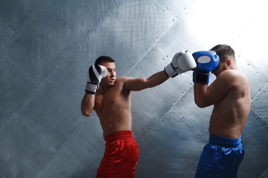Two men in muay thai shorts and gloves